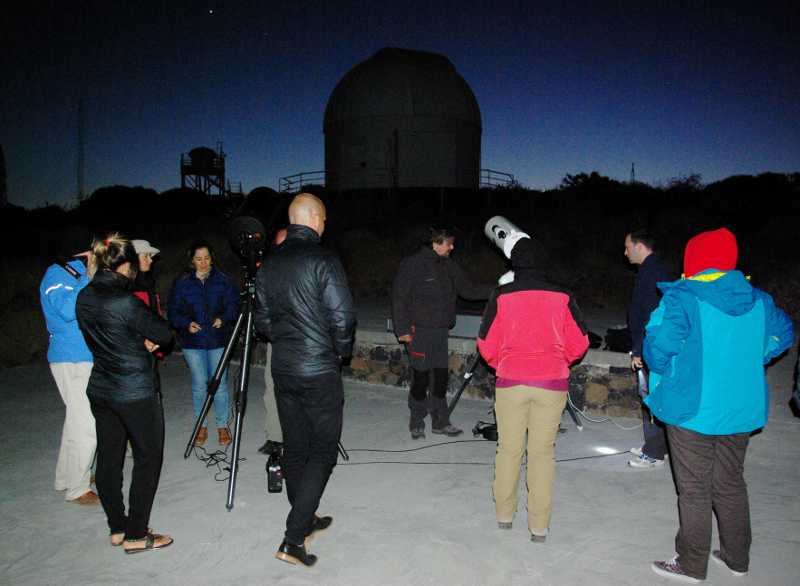 Two telescopes plus people enjoying them