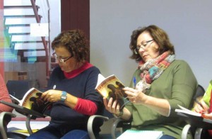 Tere and Magda checking out Sheila Crosby's anthology of children's stories, 'The Seer's Stone"'